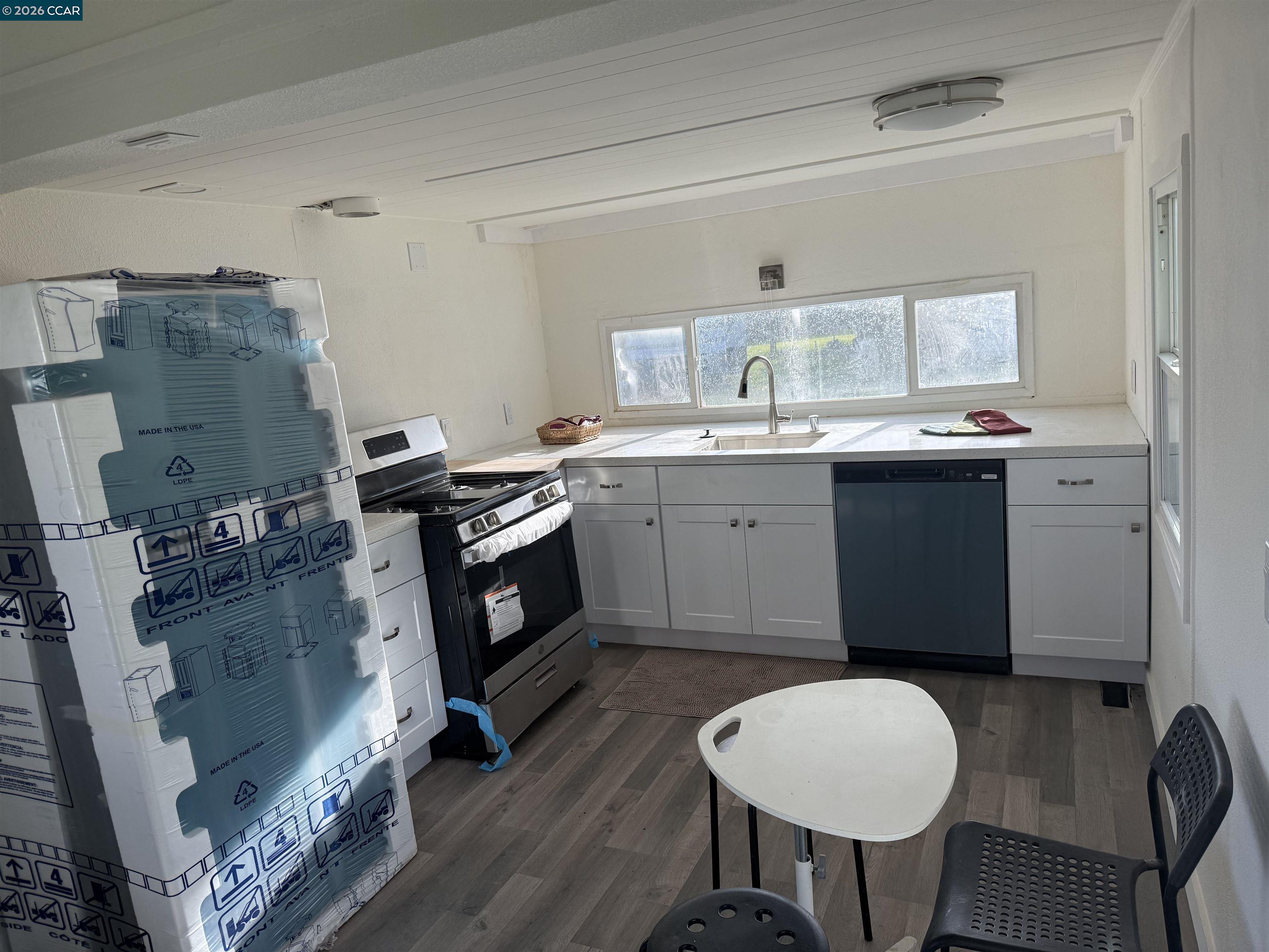 3505 Gateway Road, Unit 13M Bethel Island, CA 94511 - Photo 5 of 17 a kitchen with a sink cabinets and wooden floor