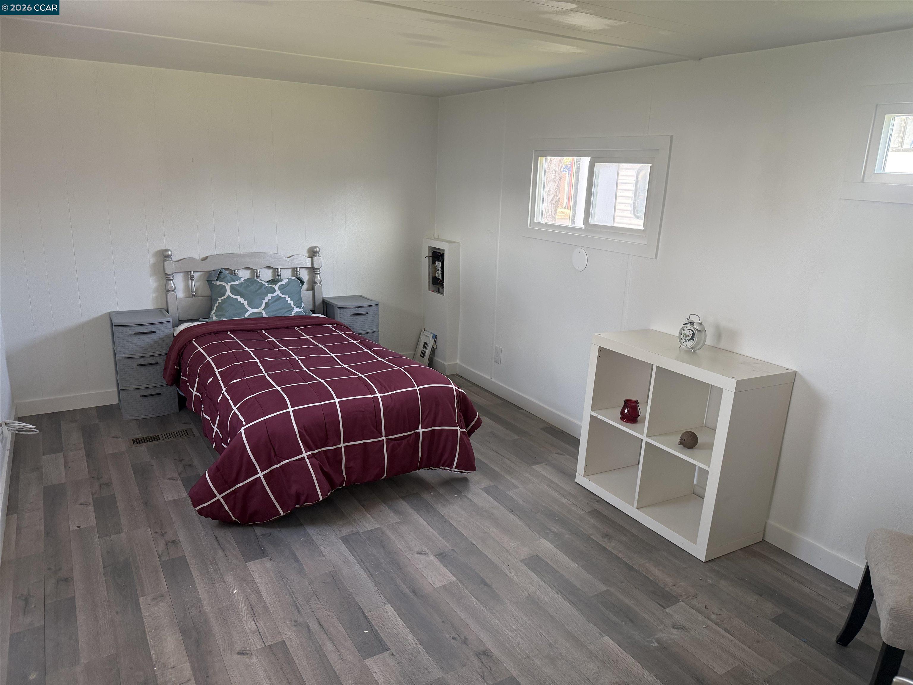 3505 Gateway Road, Unit 13M Bethel Island, CA 94511 - Photo 8 of 17 a room with a bed and wooden floor