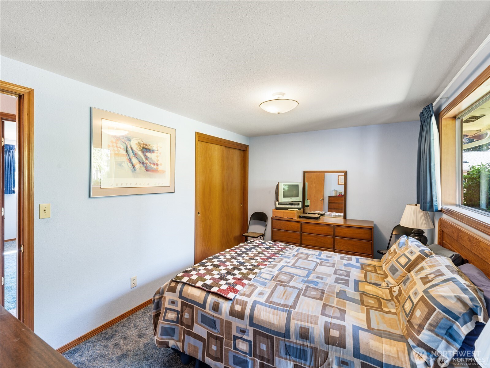 1205 South Walnut Street Burlington, WA 98233 - Photo 25 of 40 a bedroom with a bed and dresser with mirror