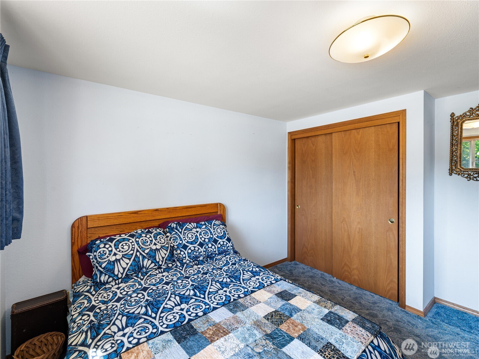 1205 South Walnut Street Burlington, WA 98233 - Photo 27 of 40 a bedroom with a bed and a painting on the wall