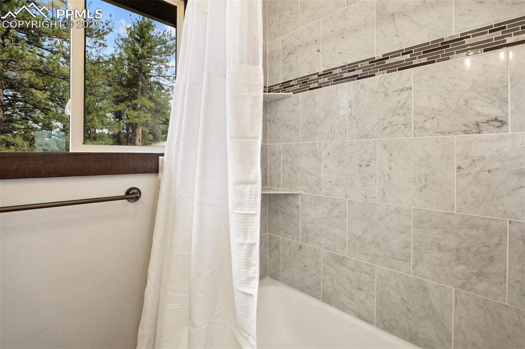 39609 Highway 24 Lake George, CO 80827 - Photo 18 of 46 Master Bathroom featuring shower / tub combo with curtain