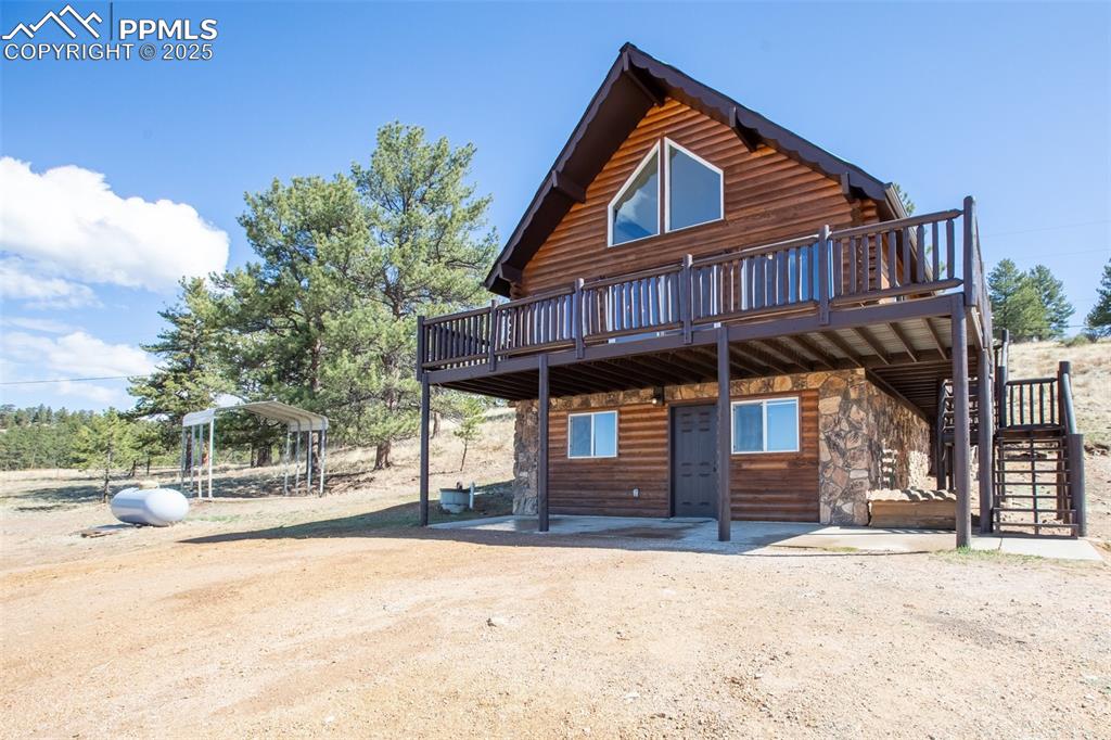 39609 Highway 24 Lake George, CO 80827 - Photo 3 of 46 View of front of property with stairway, a deck, and stone siding