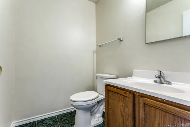 a bathroom with a sink a toilet and mirror