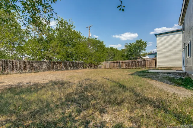 a view of backyard with green space