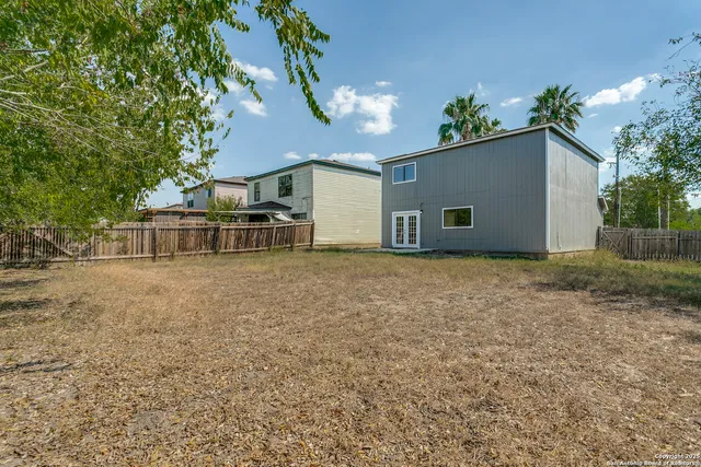 a house that has a tree in front of it
