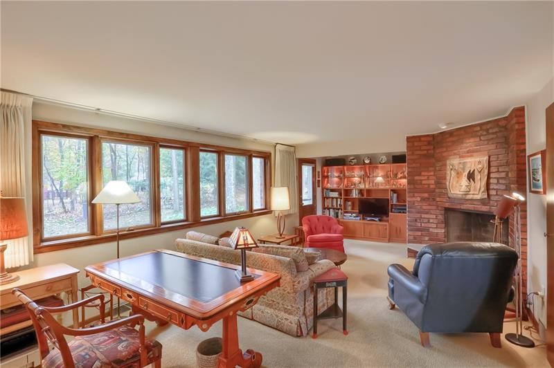 9384 Hilliard Road Pittsburgh, PA 15237 - Photo 11 of 25 Oversized family room offers a bank of windows and fireplace. The door accesses the rear yard and concrete patio.