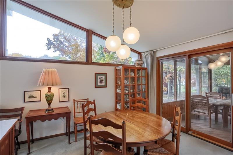 9384 Hilliard Road Pittsburgh, PA 15237 - Photo 7 of 25 The dining room slider accesses the wonderful screened porch. Beautiful clearstory windows and valued ceilings and another view of the mid century styled chandelier.