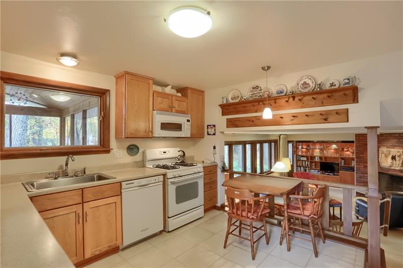 9384 Hilliard Road Pittsburgh, PA 15237 - Photo 9 of 25 The kitchen has been updated with oak cabinets with soft close drawers. The window looks out to the screened porch and yard. Kitchen is open to the 24*13 family room with fireplace.