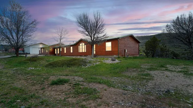 a front view of house with yard and trees