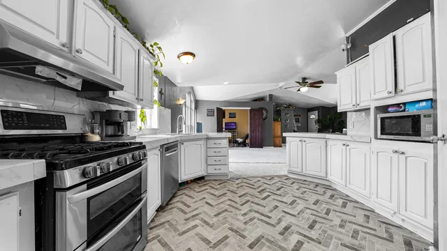 a kitchen with stainless steel appliances granite countertop a stove and a sink