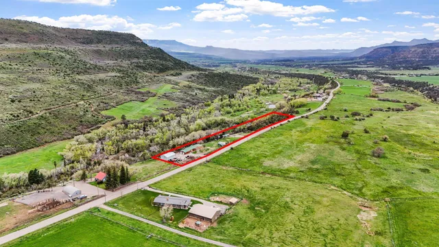 a view of a lush green hillside and houses