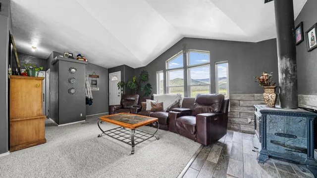 a living room with furniture windows and a flat screen tv