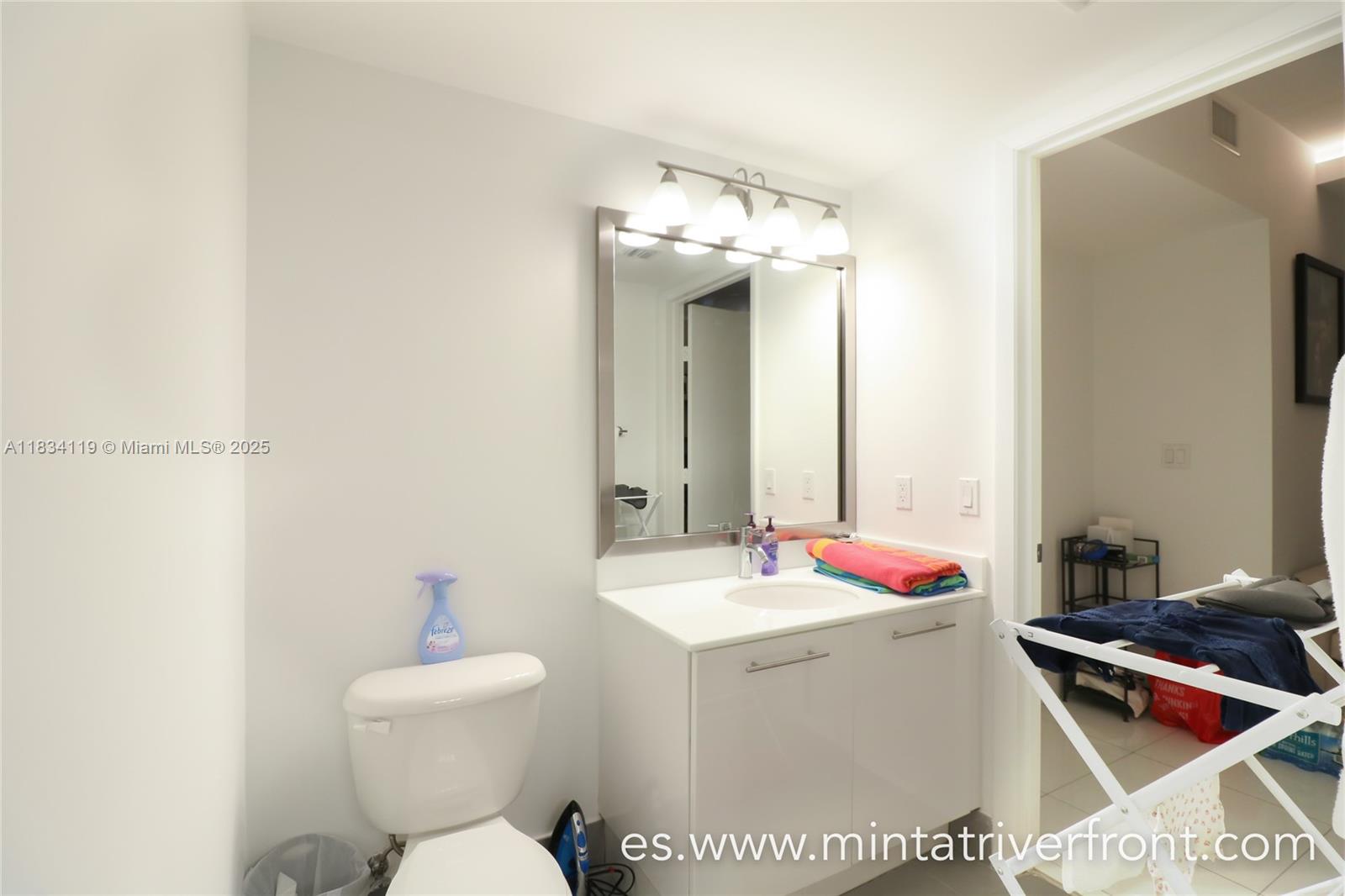 92 Southwest 3rd Street, Unit 3003 Miami, FL 33130 - Photo 10 of 15 a bathroom with a sink toilet and mirror