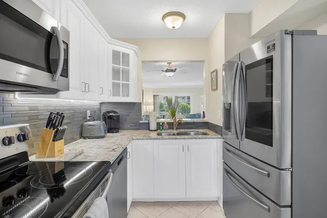 a kitchen with a sink stove and refrigerator