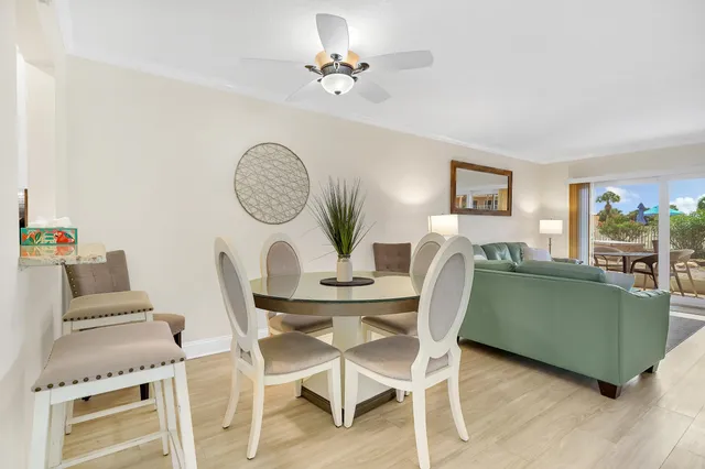 a view of a dining room with furniture and a chandelier