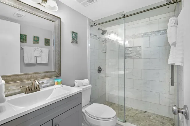 a bathroom with a sink toilet and shower