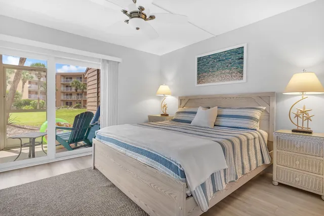 a bed room with a bed and a chair