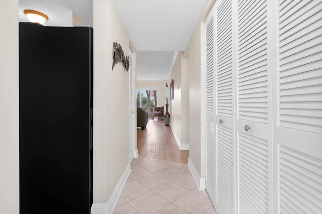 a view of a hallway with a livingroom and a window