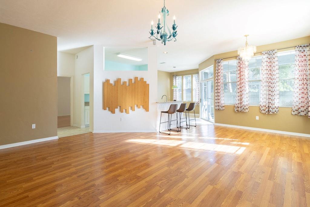 9918 Southwest 52nd Road Gainesville, FL 32608 - Photo 12 of 30 a view of a livingroom with a furniture wooden floor and a large window