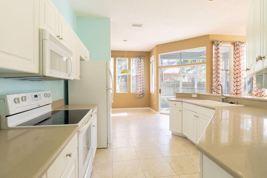 9918 Southwest 52nd Road Gainesville, FL 32608 - Photo 14 of 30 a kitchen with stainless steel appliances granite countertop a sink and a stove