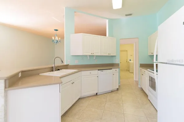 a kitchen with a sink and a refrigerator