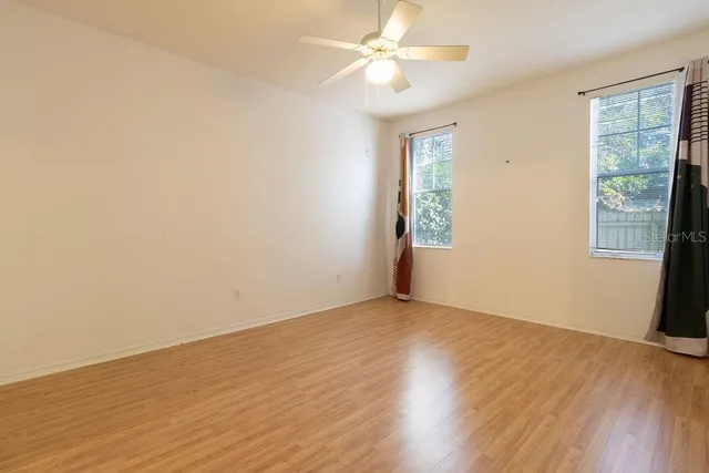 a spacious bathroom with a shower sink and mirror