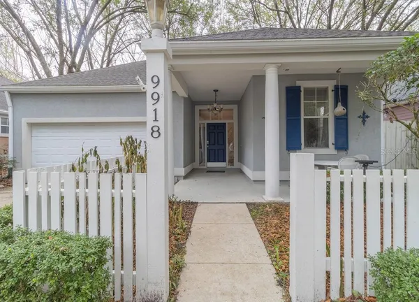 a view of a house with a wooden fence