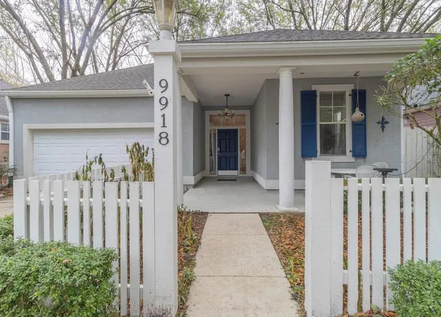 a view of a house with a wooden fence