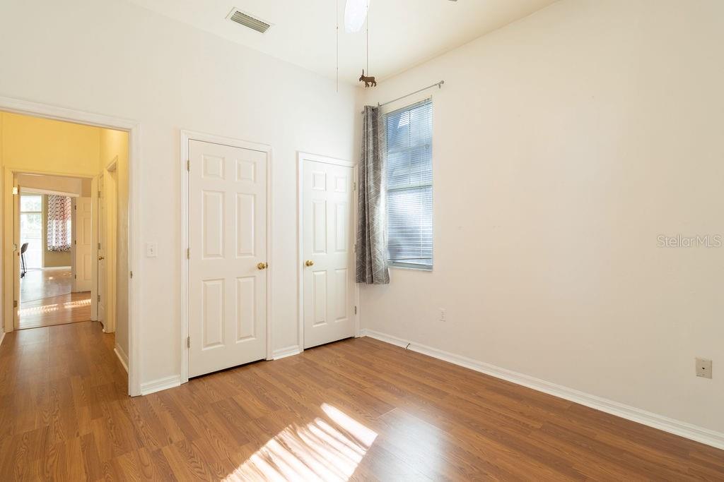9918 Southwest 52nd Road Gainesville, FL 32608 - Photo 7 of 30 a view of an empty room with wooden floor