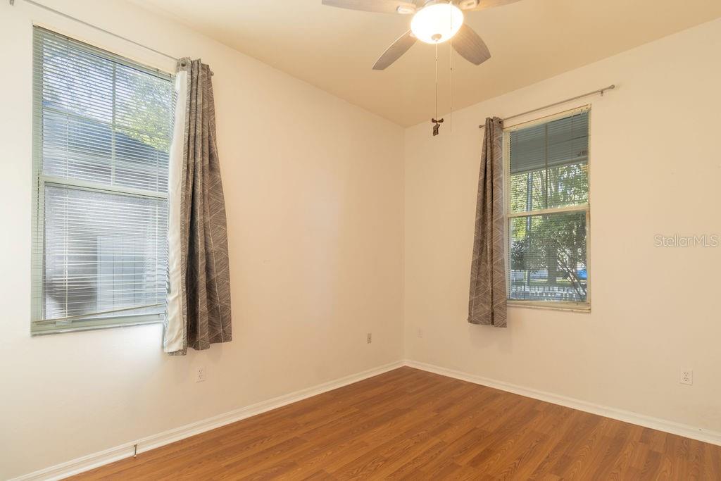 9918 Southwest 52nd Road Gainesville, FL 32608 - Photo 8 of 30 a view of an empty room with wooden floor and a window
