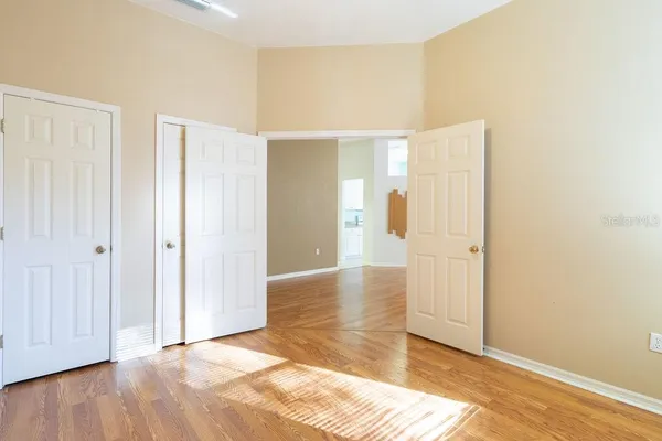 a view of an empty room with wooden floor