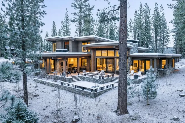 a front view of a house with yard and trees