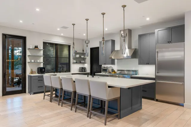 a living room with patio furniture and a potted plant