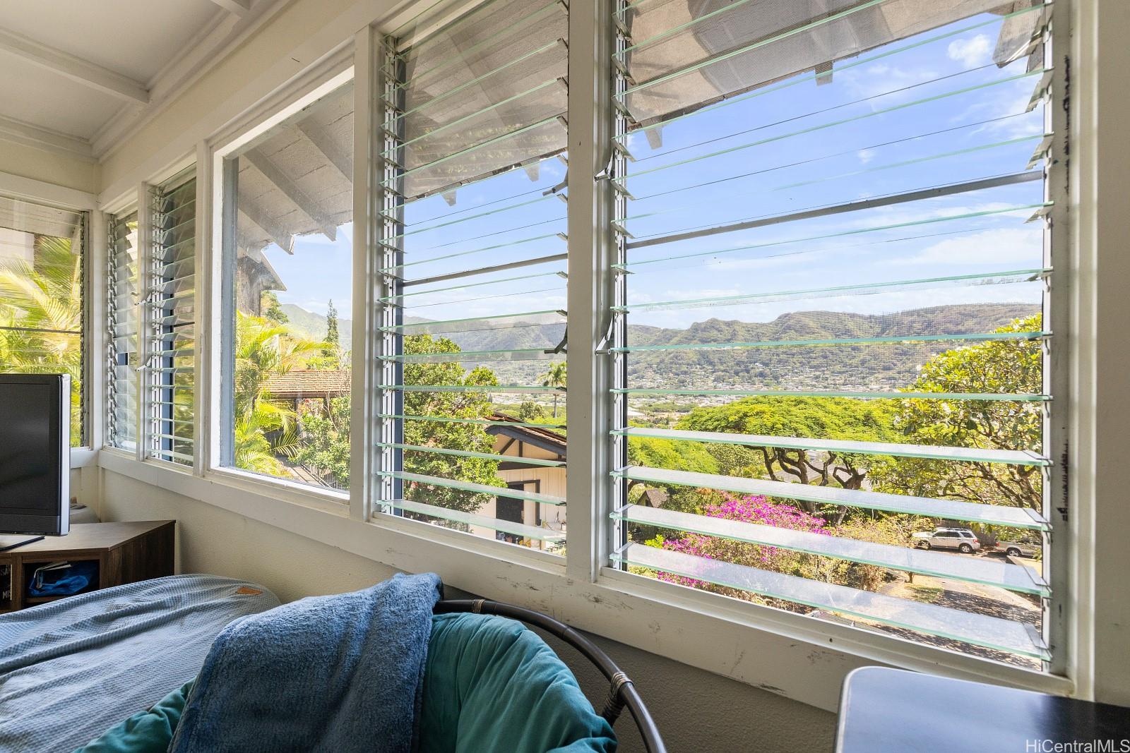 2870 Komaia Place, Unit 2870A AND 2884 Honolulu, HI 96822 - Photo 13 of 25 a bedroom with a bed and a large window with garden view