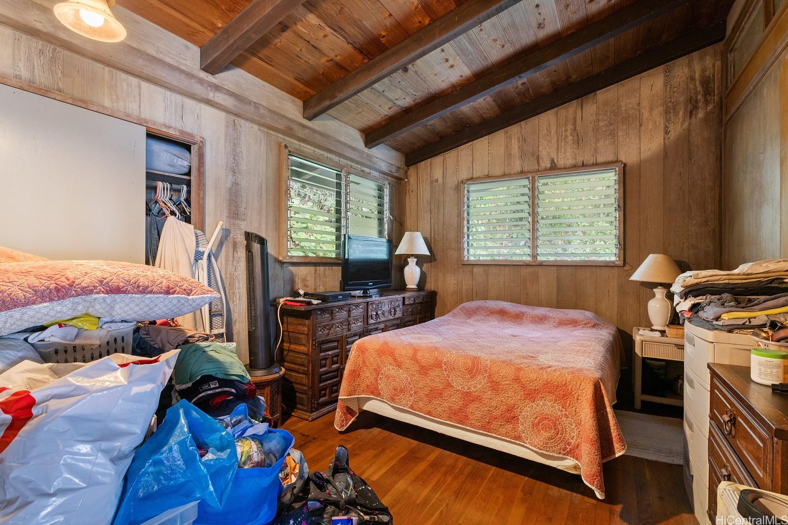2870 Komaia Place, Unit 2870A AND 2884 Honolulu, HI 96822 - Photo 23 of 25 a bedroom with a bed and wooden floor