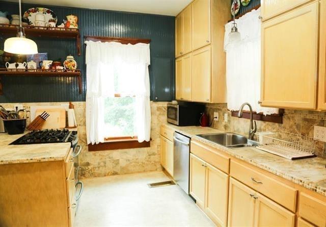 433 West Washington Street Paris, TX 75460 - Photo 8 of 12 a kitchen with a sink and a refrigerator