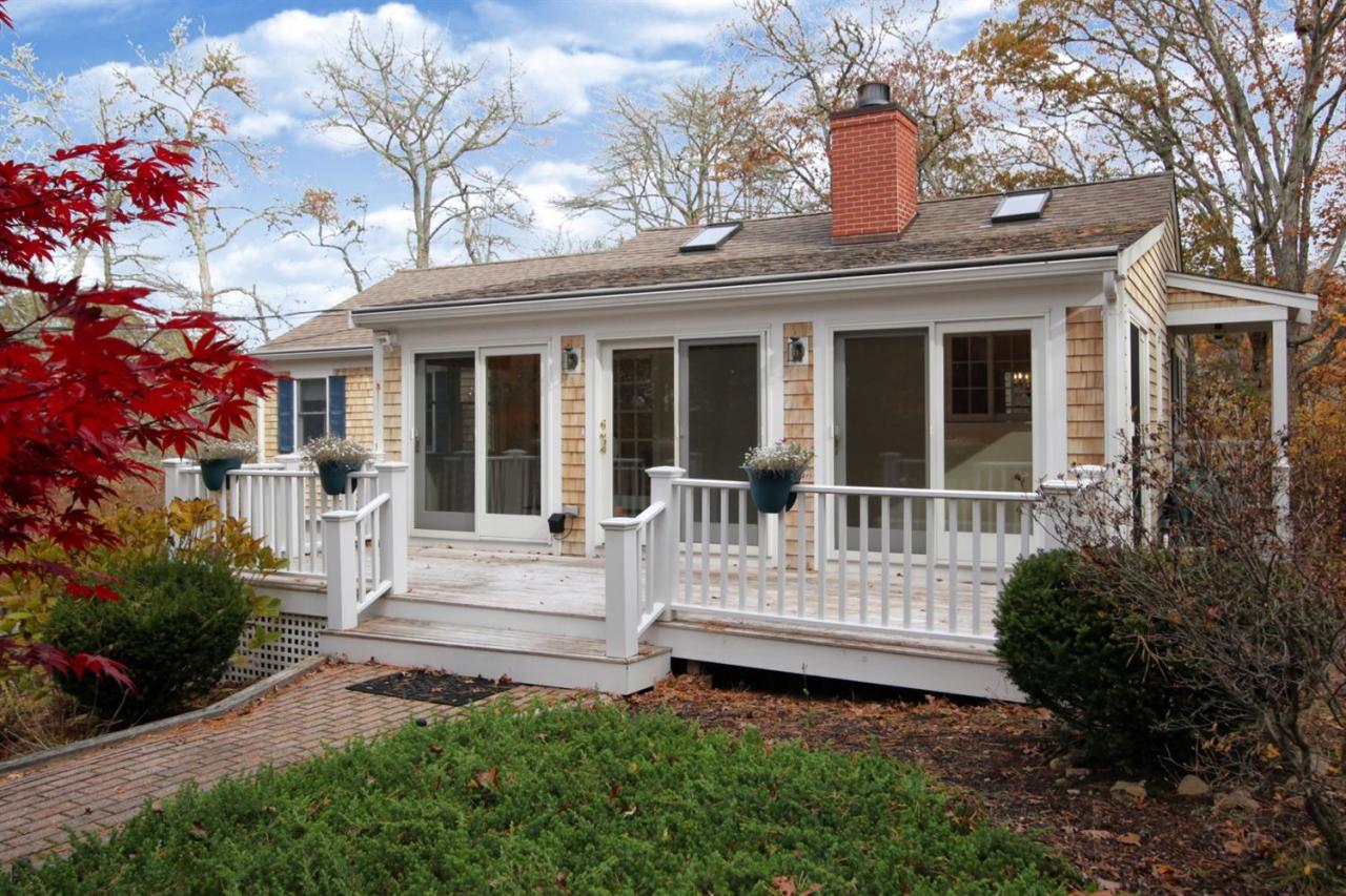 44 Nyes Neck Road Centerville, MA 02632 - Photo 4 of 20 a view of a house with a small yard and flower plants