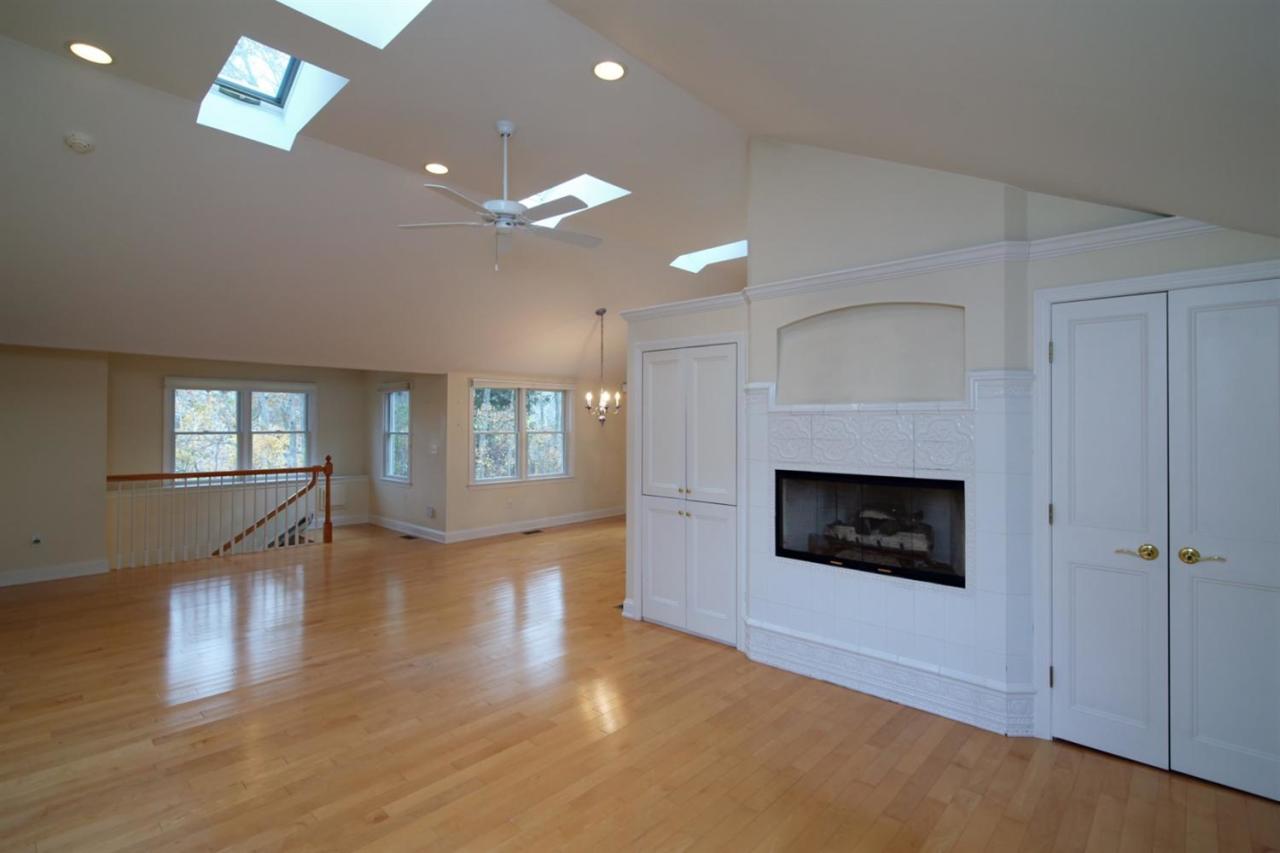 44 Nyes Neck Road Centerville, MA 02632 - Photo 7 of 20 an empty room with windows and fireplace