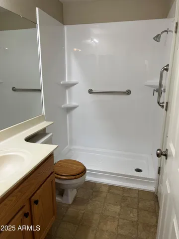 a bathroom with a sink a toilet and a shower