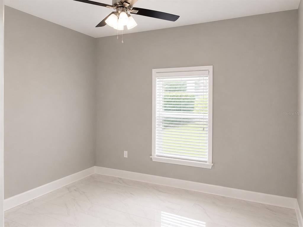 3834 Charter Road Lakeland, FL 33810 - Photo 21 of 39 an empty room with a window and a fan