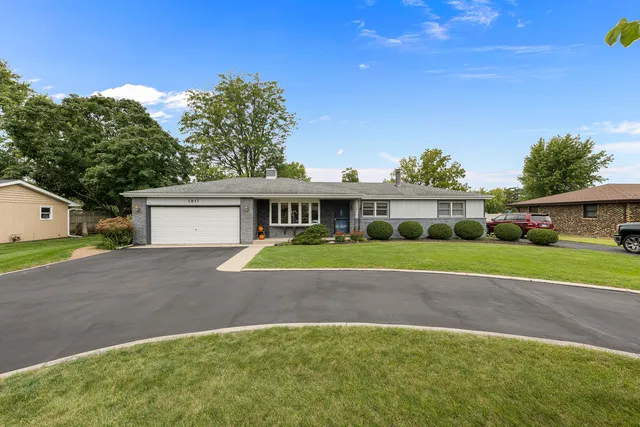 a front view of house with yard and green space