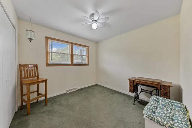 a bathroom with a granite countertop sink a toilet a mirror a vanity and shower