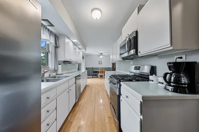 a kitchen with stainless steel appliances granite countertop lots of counter top space a stove and a refrigerator