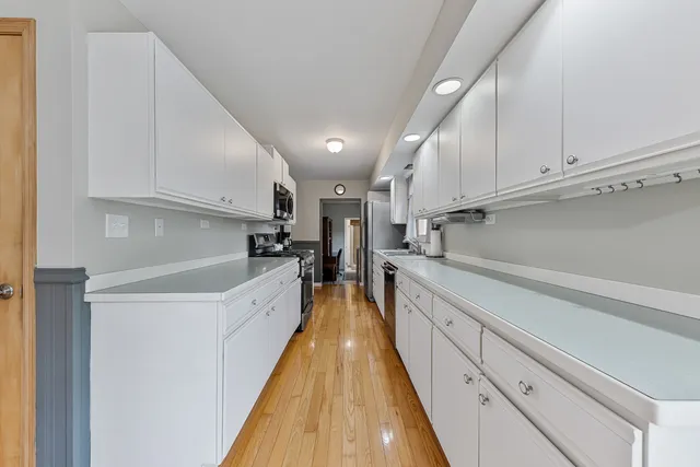 a kitchen with kitchen island granite countertop lots of counter top space and cabinets