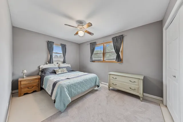 a bedroom with a bed dresser and a window