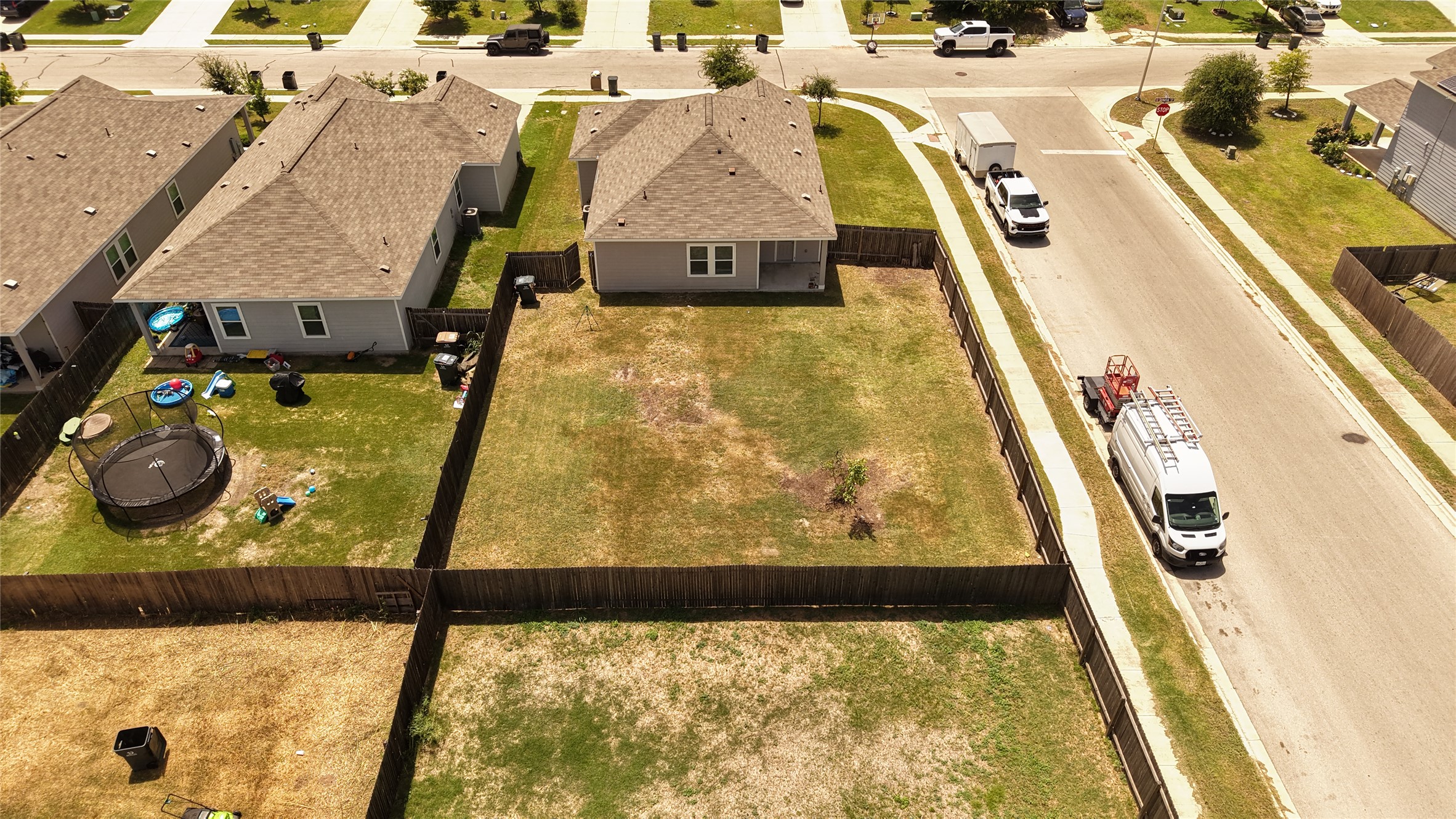 250 Seneca Loop Kyle, TX 78640 - Photo 2 of 22 A fenced backyard offers ample space for outdoor activities and future landscaping visions.