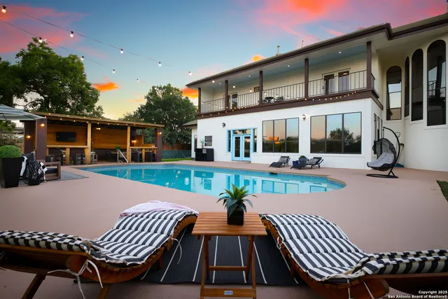 a view of a patio with couches chairs and wooden floor