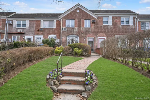a front view of a house with a garden and pathway