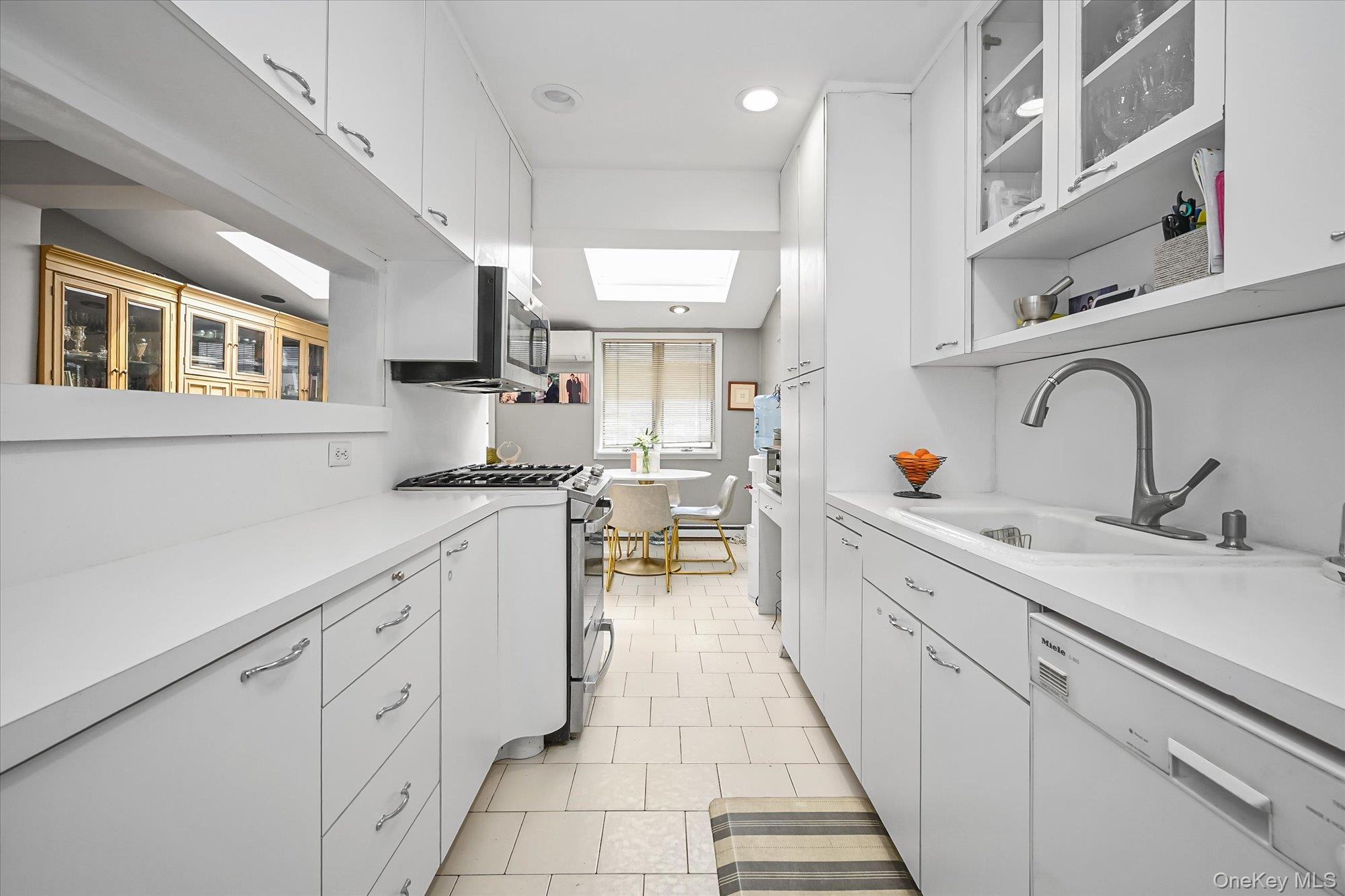 136-54 71st Road Queens, NY 11367 - Photo 11 of 25 a kitchen with white cabinets and sink