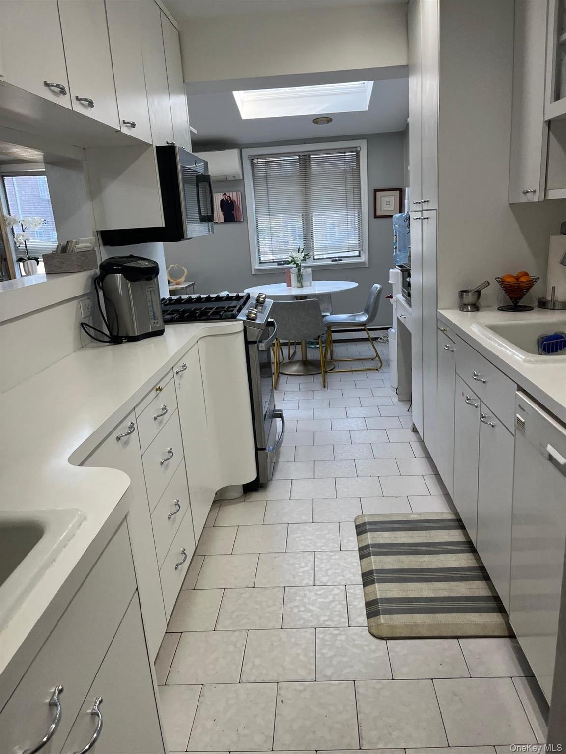 136-54 71st Road Queens, NY 11367 - Photo 13 of 25 a kitchen with stainless steel appliances a sink stove and cabinets